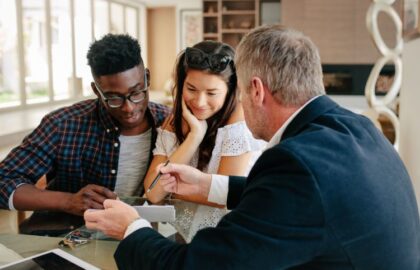 Realtor Explaining Lease Agreement to in Interracial Couple