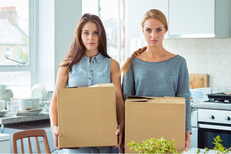 Two Angry Roommates Holding Cardboard Boxes